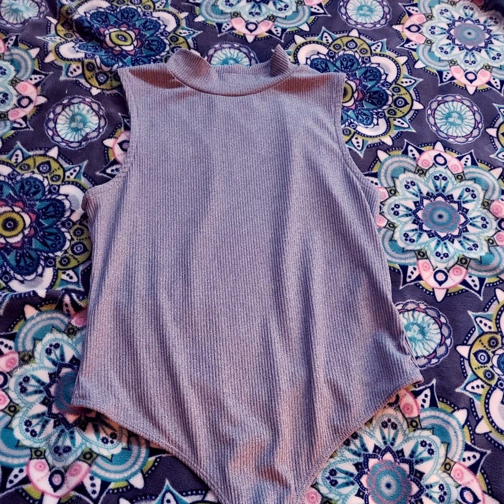 grey half way turtle neck buttons at the bottem